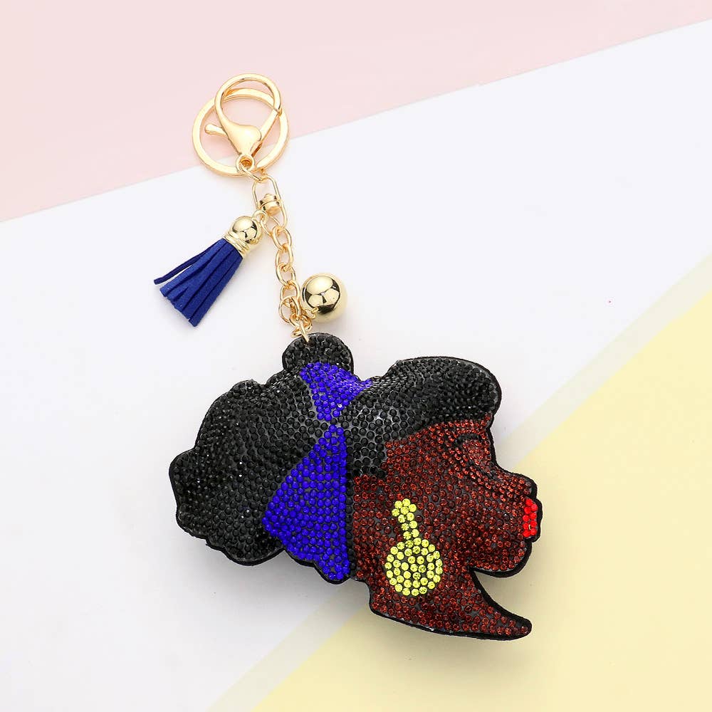 Black rhinestone Afro woman keychain with blue headwrap, red lips, and yellow earrings – includes gold clasp, tassel, and charm for bags or purses.