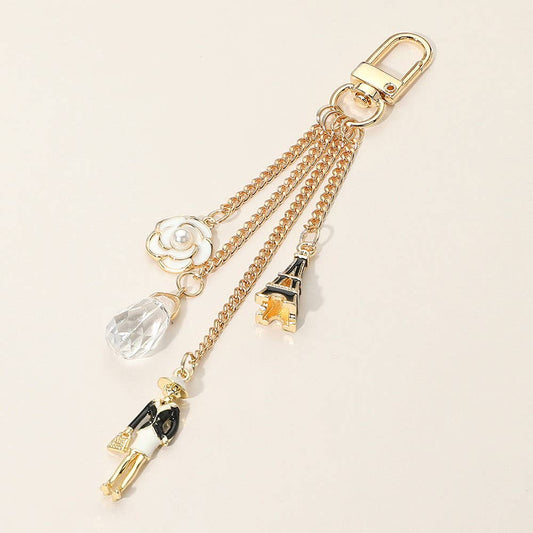 Enamel Eiffel Tower Lady Charm Keychain – Gold Bag Accessory with Flower Detail | Sensibling Corp.